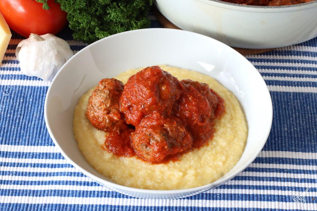 Italian Meatballs with polenta in a serving bowl. 