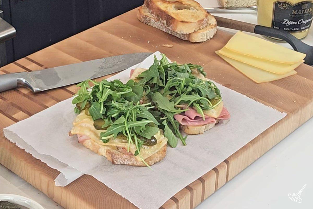 Arugula on top of a sandwich.