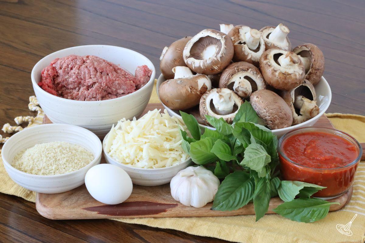 A bowl of mushrooms with another bowl of ground beef beside it.