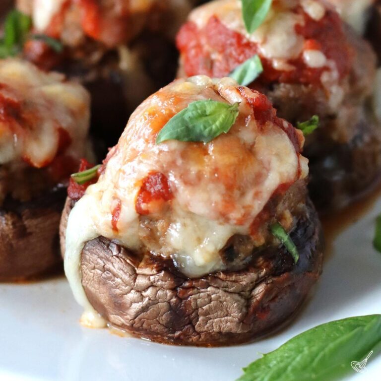 Meatball stuffed mushrooms on a plate.