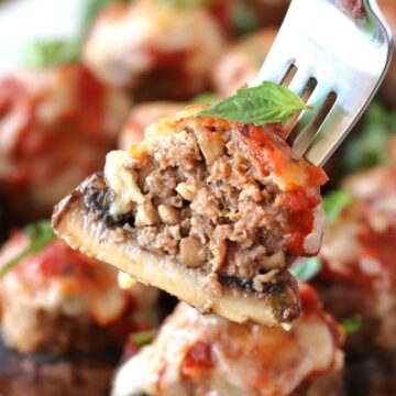 A fork holding a Meatball Stuffed Mushroom