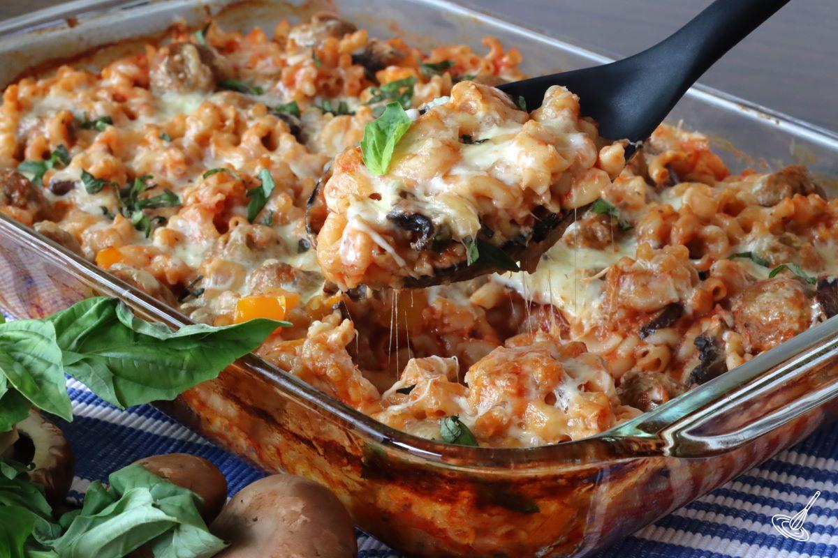Someone using a serving spoon to serve Dump and Bake Meatball Casserole.