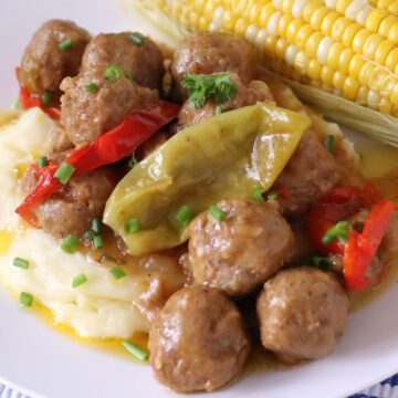 Mississippi Meatballs served over mashed potatoes on a plate.