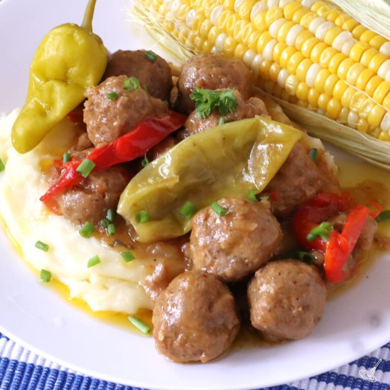 Mississippi Meatballs over mashed potatoes on a plate.