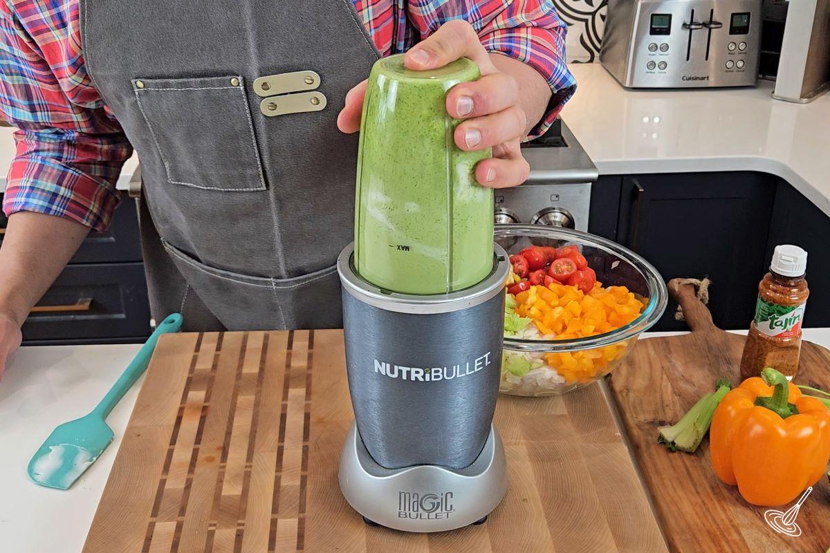 Someone blending cilantro lime dressing in a blender.