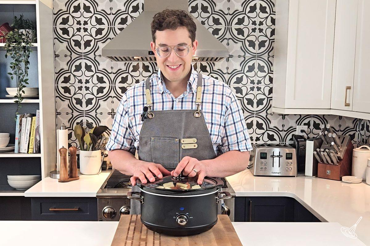 Someone placing the lid on a slow cooker.