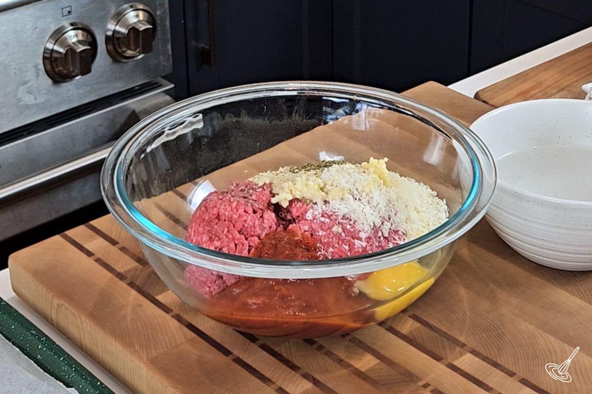 Ingredients in a large bowl to make meatballs. 