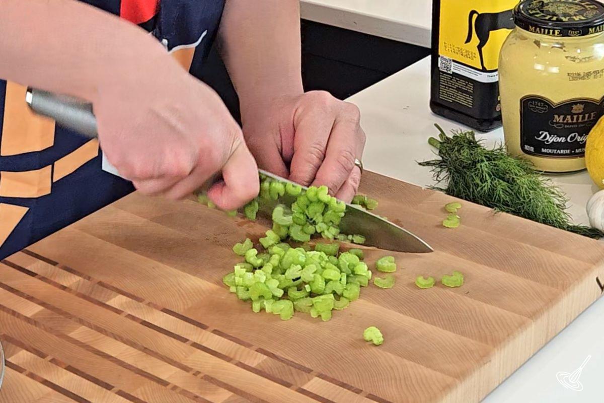 Someone cutting thin slices of celery. 