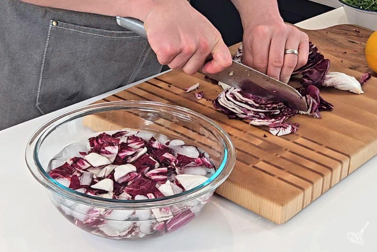 Someone chopping up a head of radicchio.