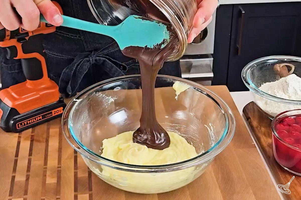 Someone pouring melted chocolate in a large bowl. 