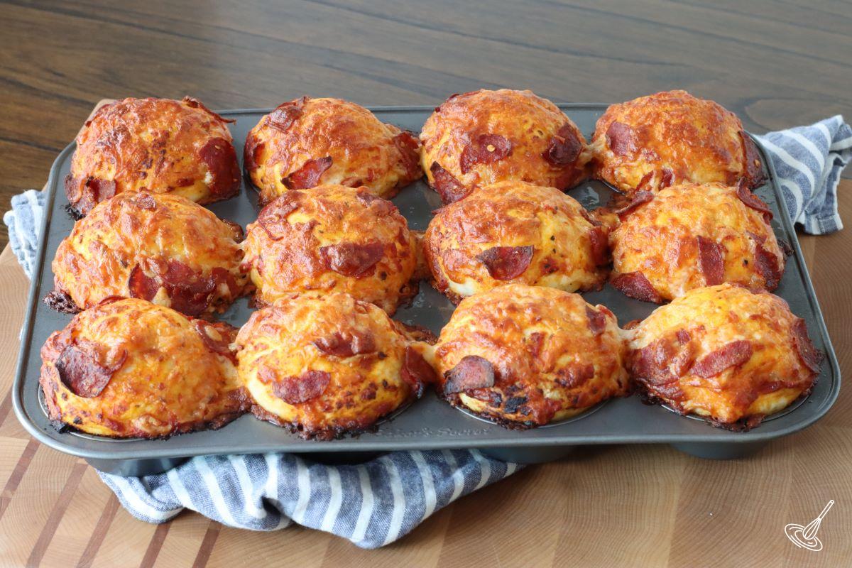 A tray of baked pizza muffins.