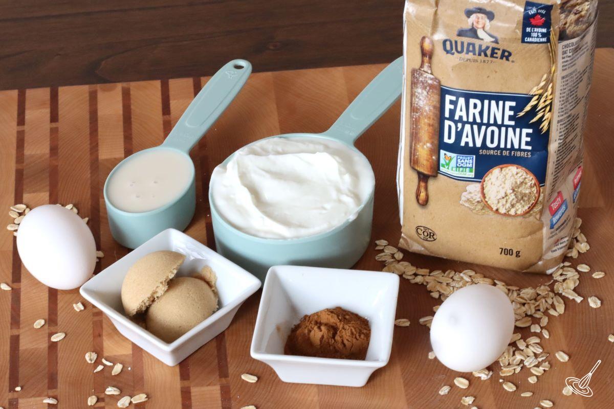 Ingredients on a tray, including Greek yogurt ,oat flour, eggs, and almond milk.