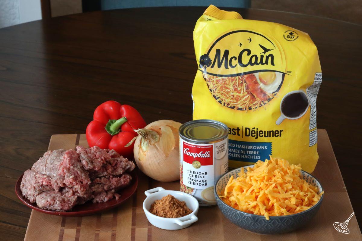 Ingredients to make Taco Hashbrown Casserole, including ground beef, grated cheese and hashbrowns.