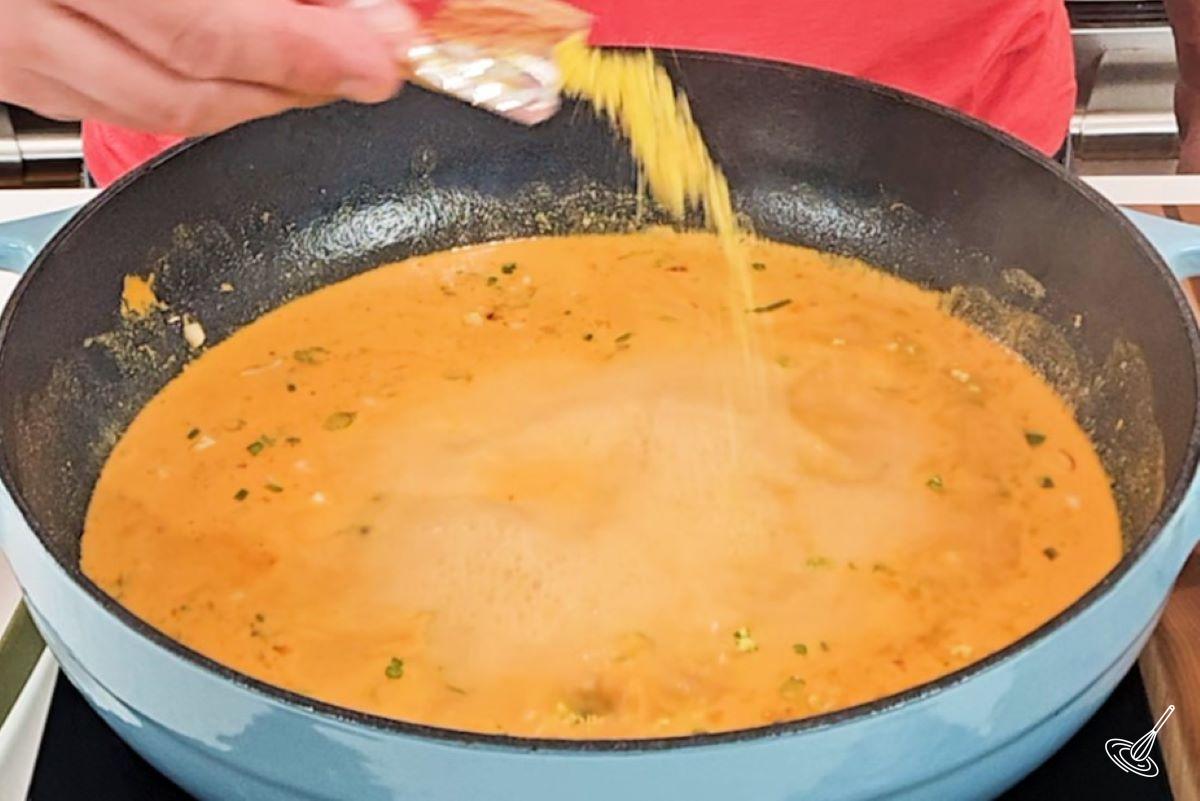 A large frying pan containing a cheese sauce.