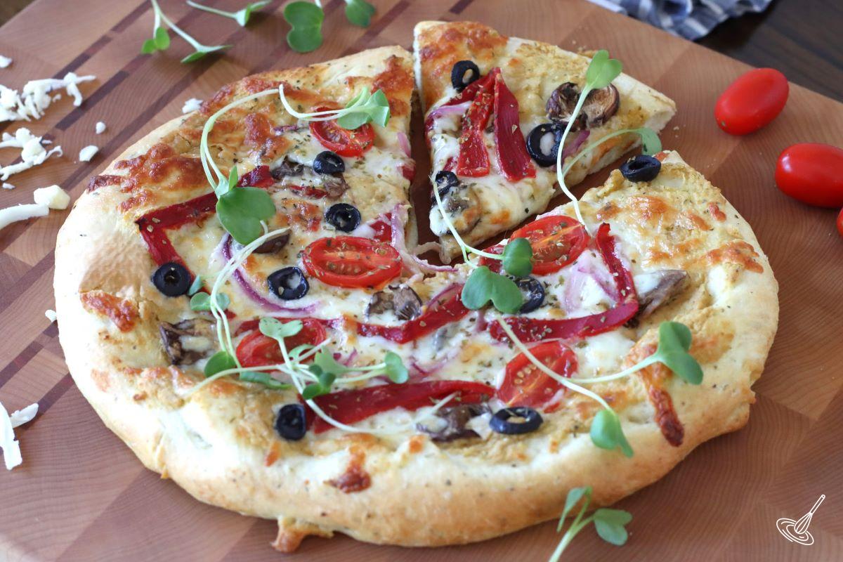 Hummus Pizza on a cutting board. 