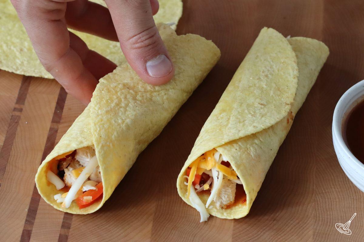 Someone rolling up an enchilada. 