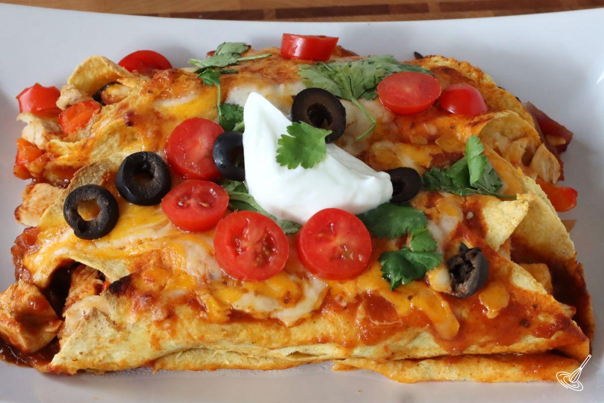 A couple enchiladas on a plate.