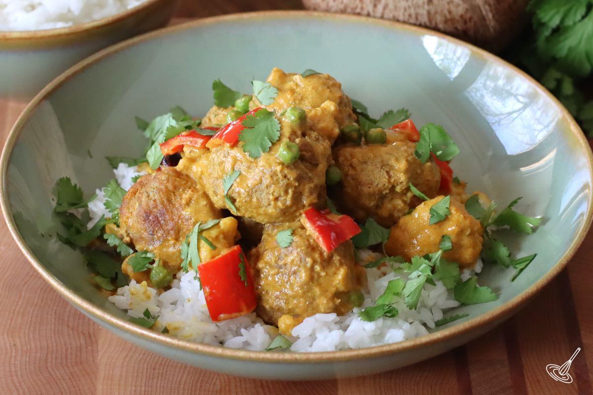 Coconut Curry Meatballs servered over rice.