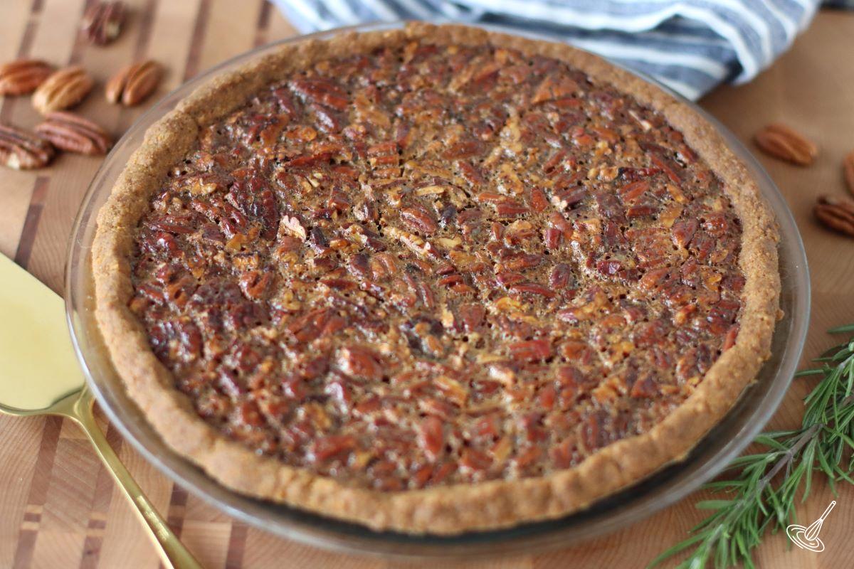 A baked Pecan Pie with graham cracker crust. 