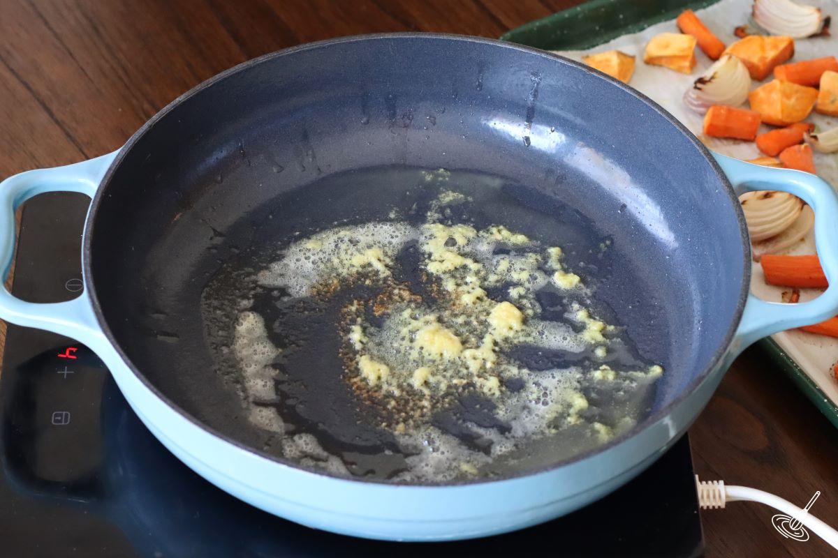 Grated ginger cooking in a pan with butter. 