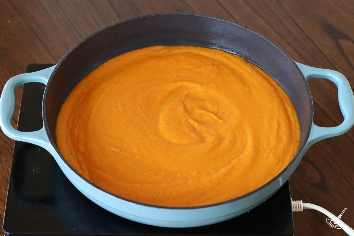 Carrot Ginger and Sweet Potato Soup blended in a large pot. 