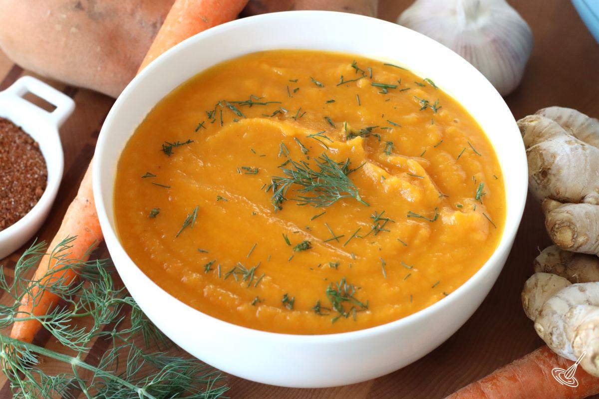 A bowl of Carrot Ginger and Sweet Potato Soup.