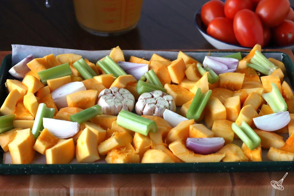 Chopped vegetables and pumpkin on a baking tray.