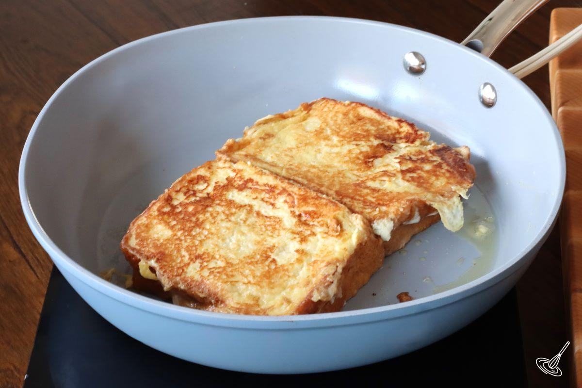 Someone frying Stuffed Brioche French Toast Orange Marmalade Recipe. 