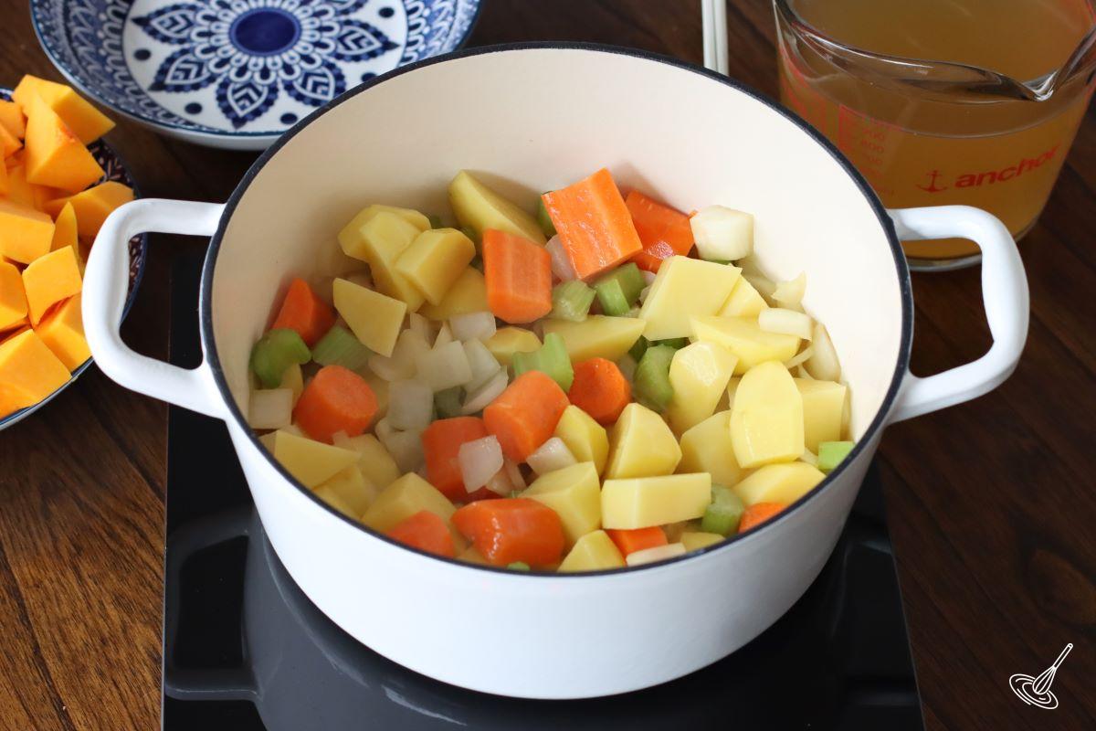 Vegetables cooking in a Dutch oven.