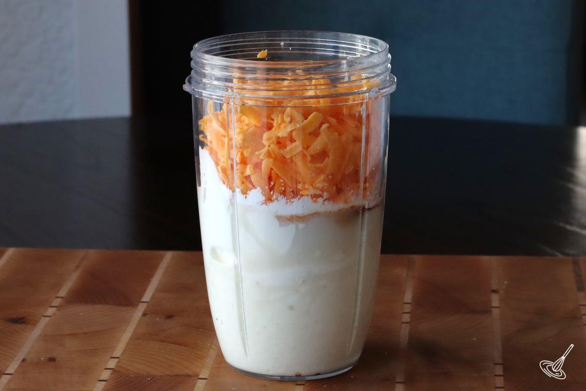 A container of cottage cheese and grated cheese.