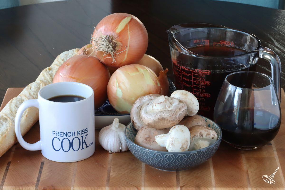 Ingredients to make French onion Soup including onion, beef broth, wine, and mushrooms.