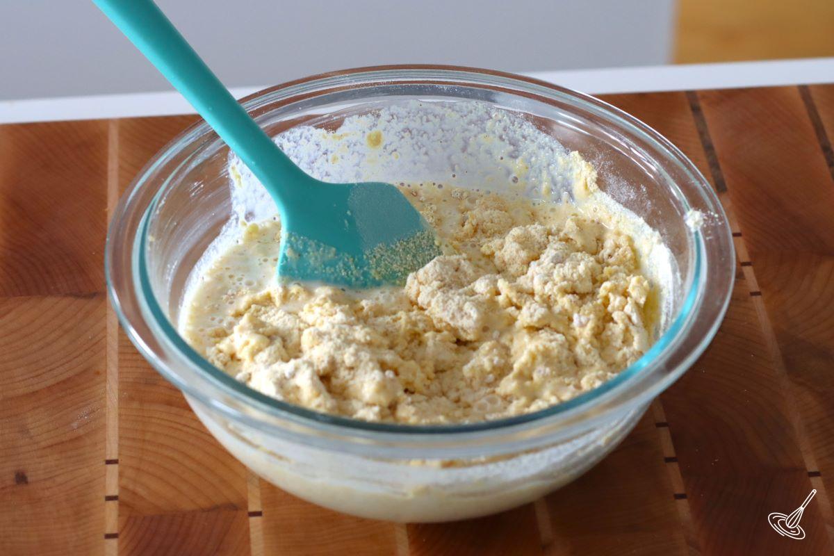 A large bowl of lumpy cornbread batter. 