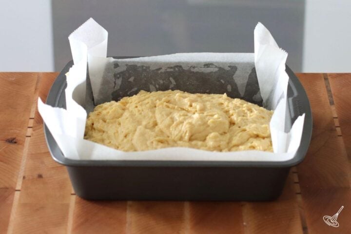 A baking tray containing cornbread batter.