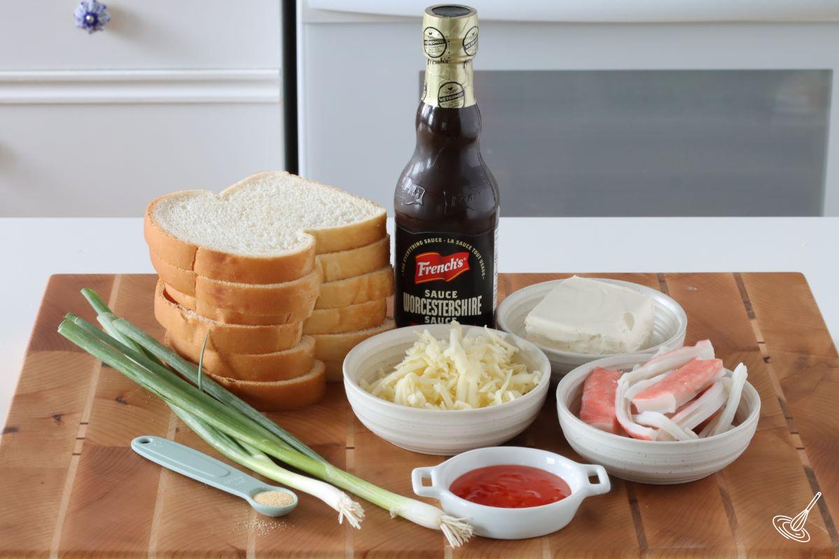 Ingredients to make Crab Rangoon Grilled Cheese, including bread, cheese, imitation crab, and green onion.