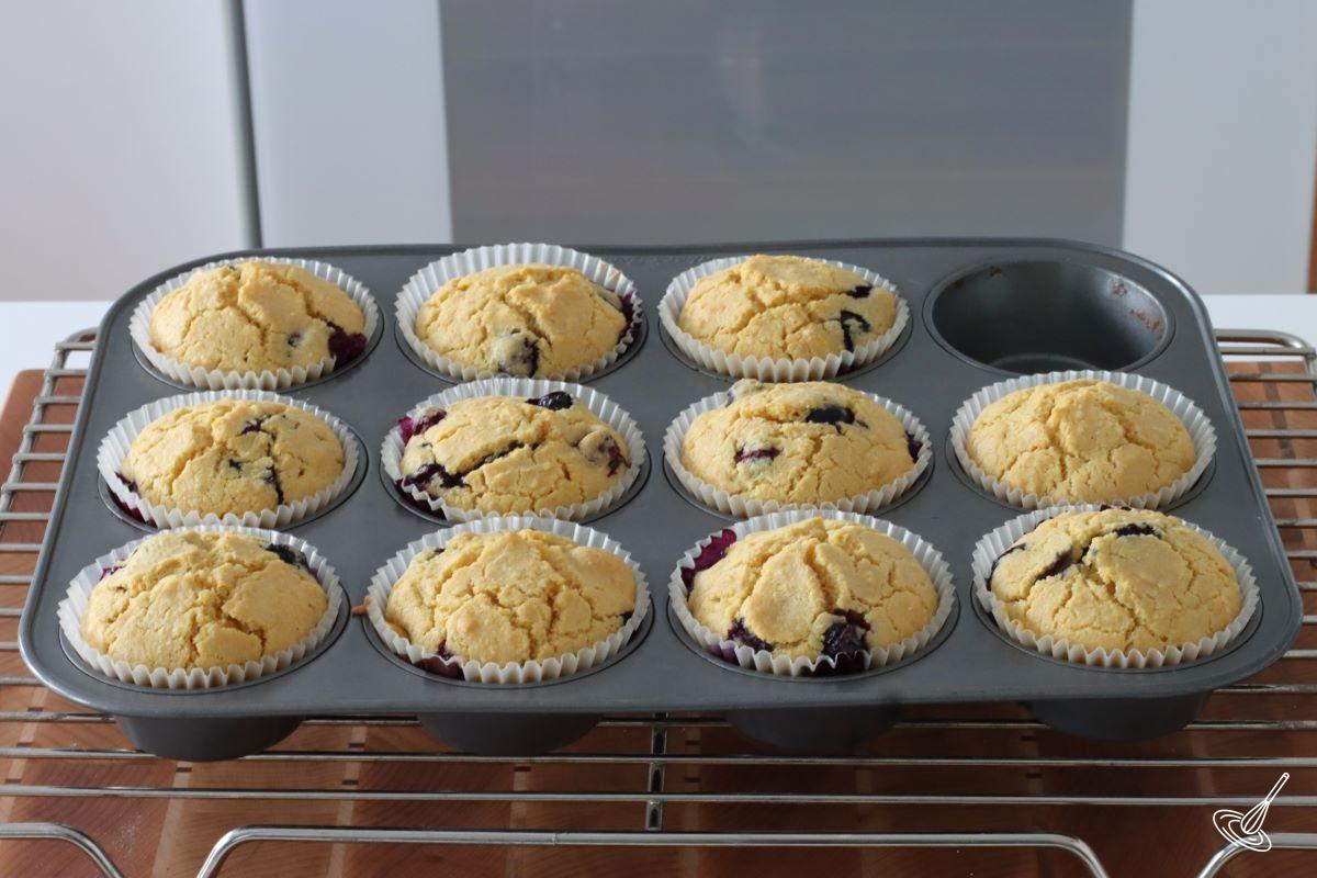  Baked Blueberry Corn Muffins in a muffin tray. 