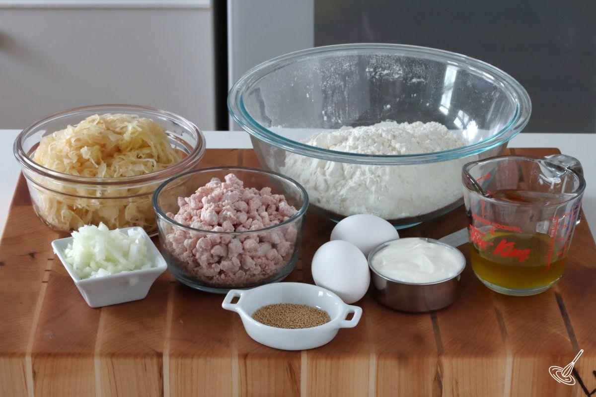 Ingredients for Pyrizhky Ukrainian Cabbage Buns, including flour, cabbage, bacon, eggs.