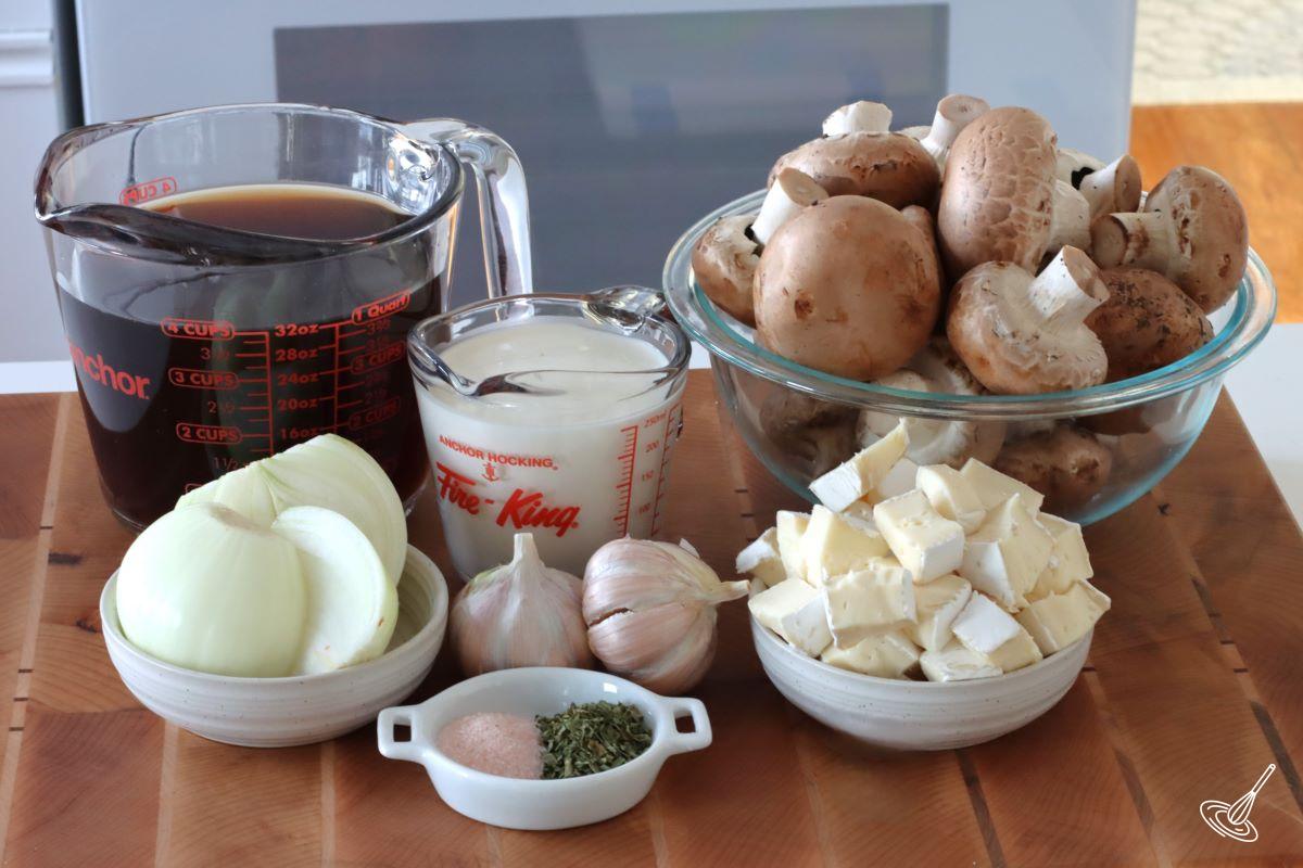 Ingredients to make mushroom soup including mushrooms, beef broth and brie. 