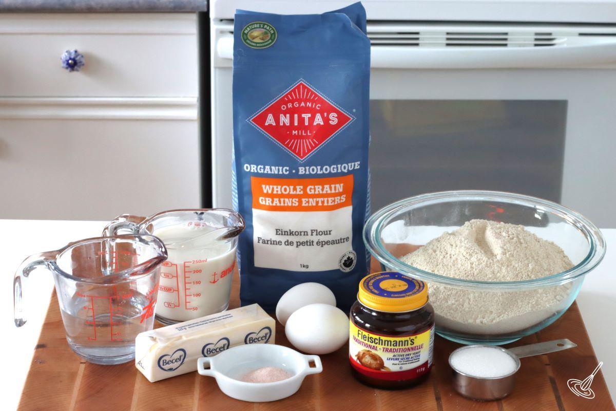 A bag of Einkorn Flour on the counter with yeast, butter, milk, and eggs.