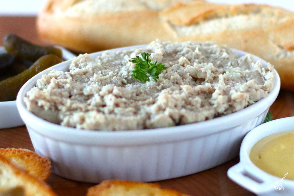 A dish of Cretons recipe with a side of mustard. 