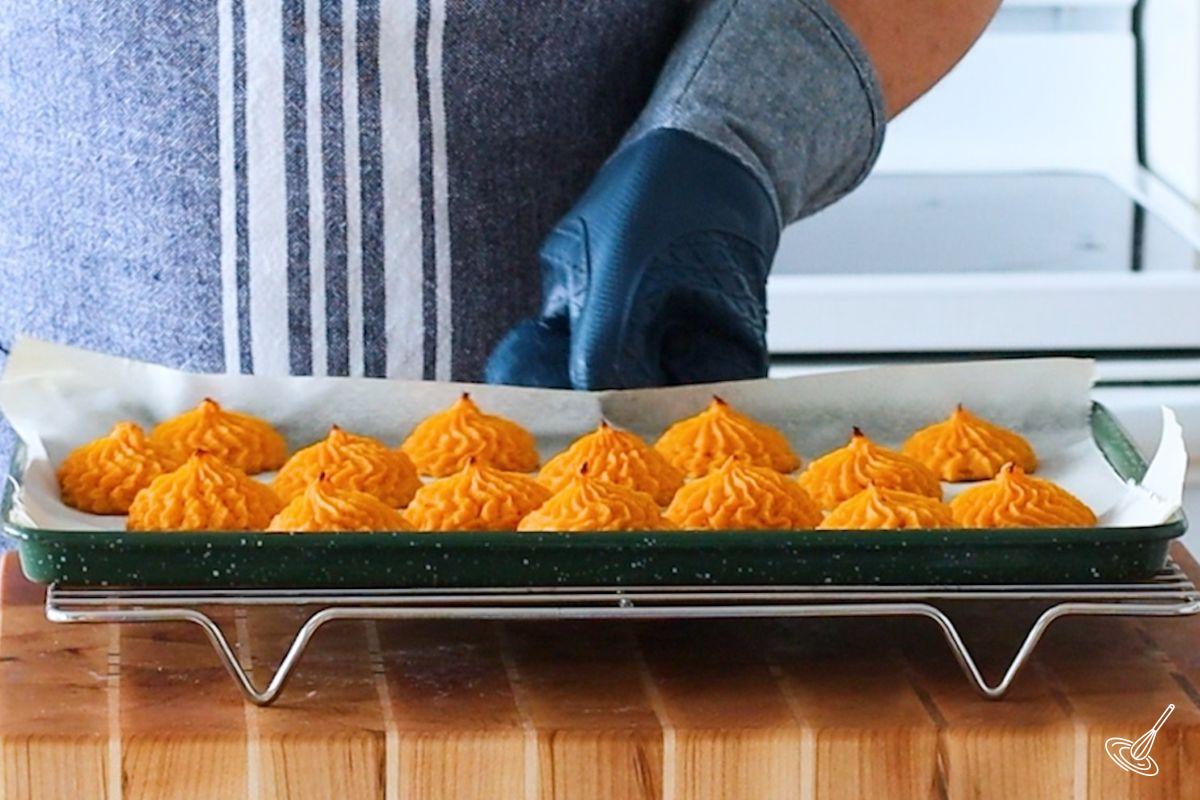 A tray of cooked duchess sweet potatoes. 
