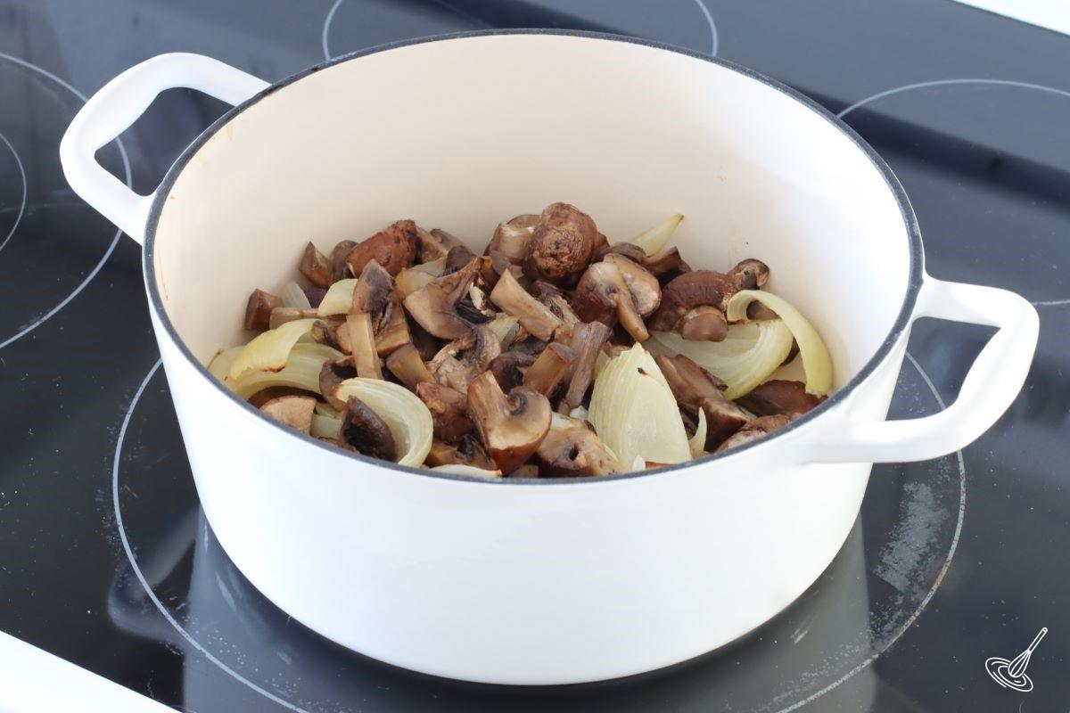 Roasted mushrooms and onion in a Dutch oven.