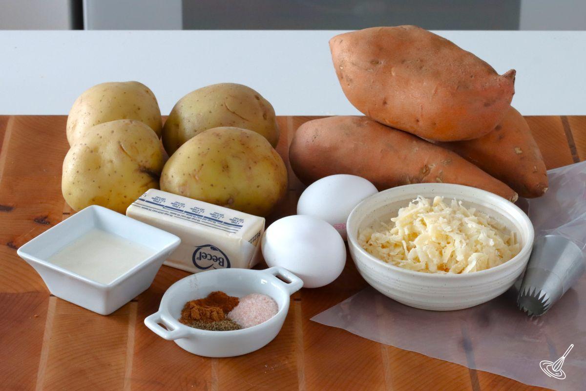 Yellow potatoes and sweet potatoes on a cutting with other ingredients. 