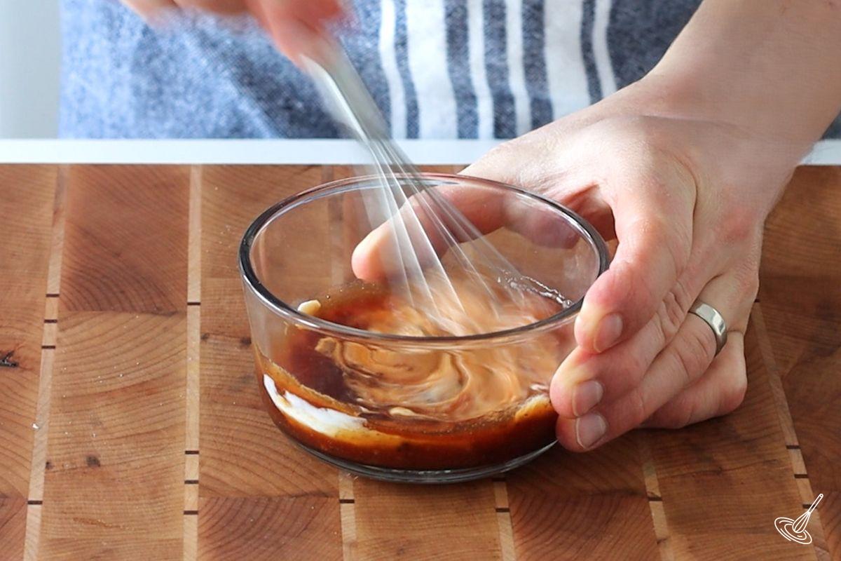 Someone making a Maple BBQ dipping sauce.