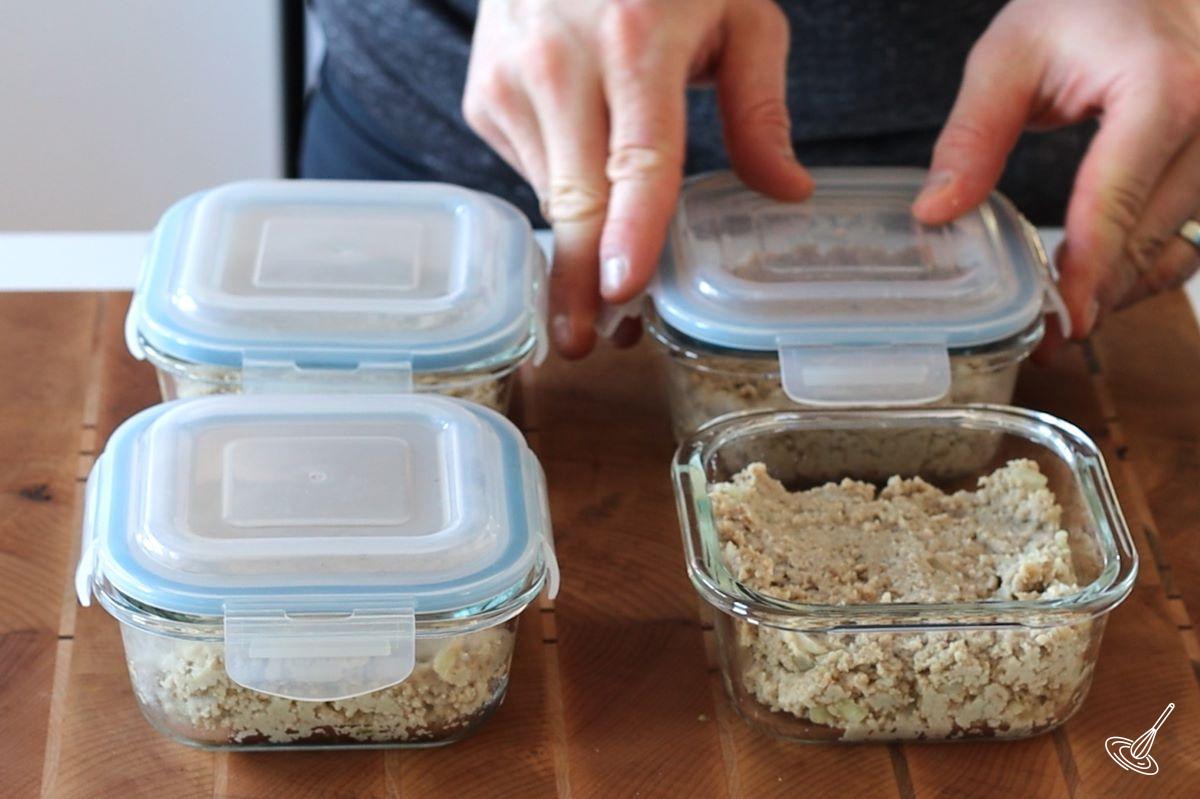 Someone placing lids on the cretons containers. 