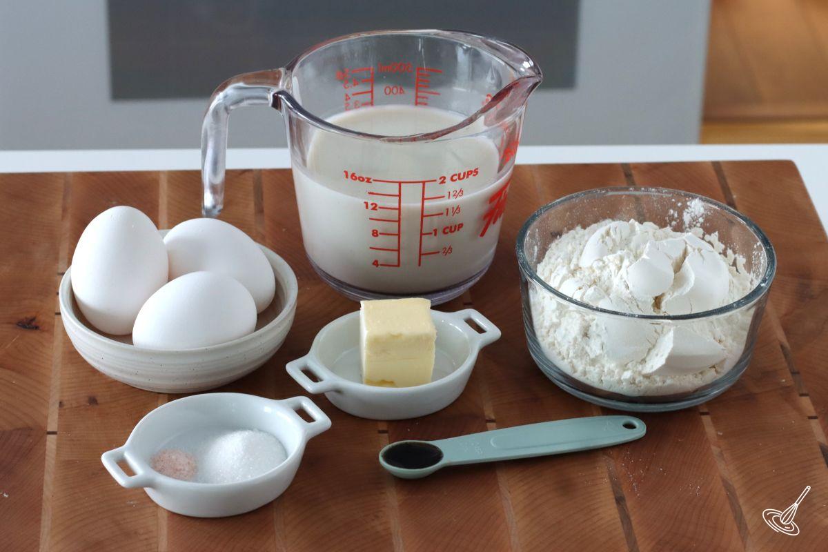 Ingredients to make Pâte à Crêpes, including milk, flour, butter, and eggs.