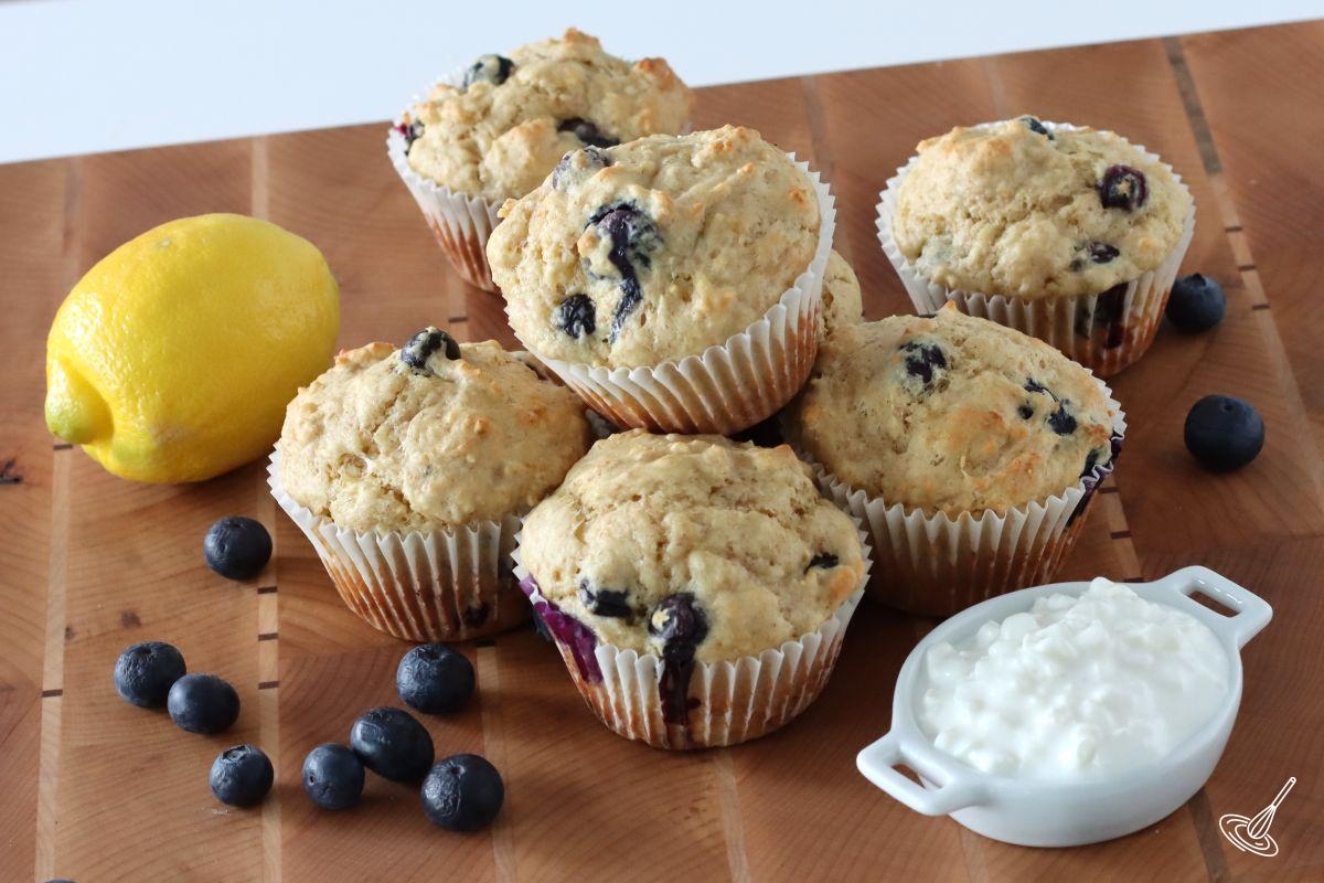 Cottage Cheese Blueberry Muffins on a wood cutting board. 