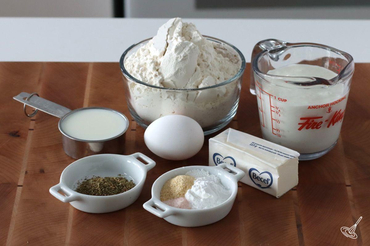 Ingredients to make Cottage Cheese Biscuits, including flour, milk, butter, and egg. 