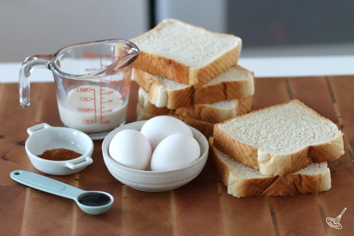 Ingredients to make French toast including bread, eggs, milk, and vanilla. 