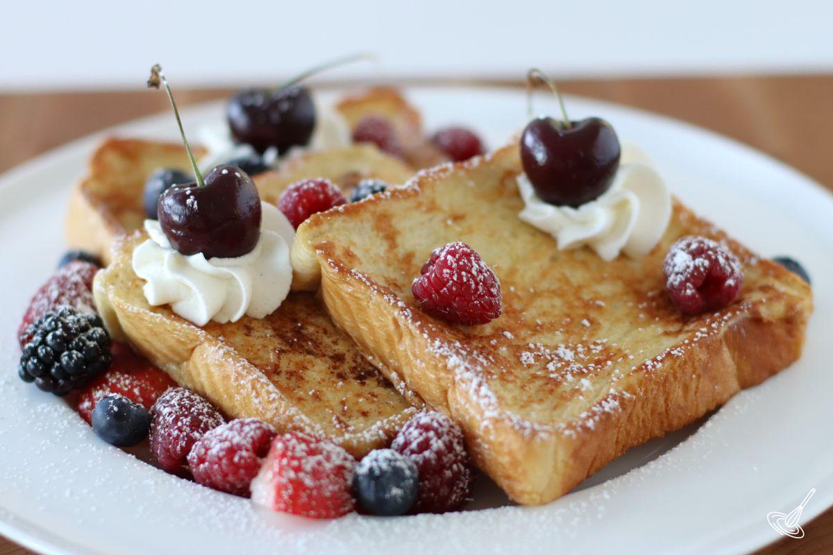 A plate of Cinnamon Vanilla French Toast garnished with fresh berries. 