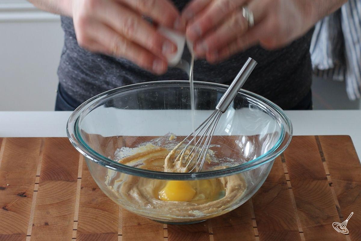 Someone cracking an egg in a bowl. 